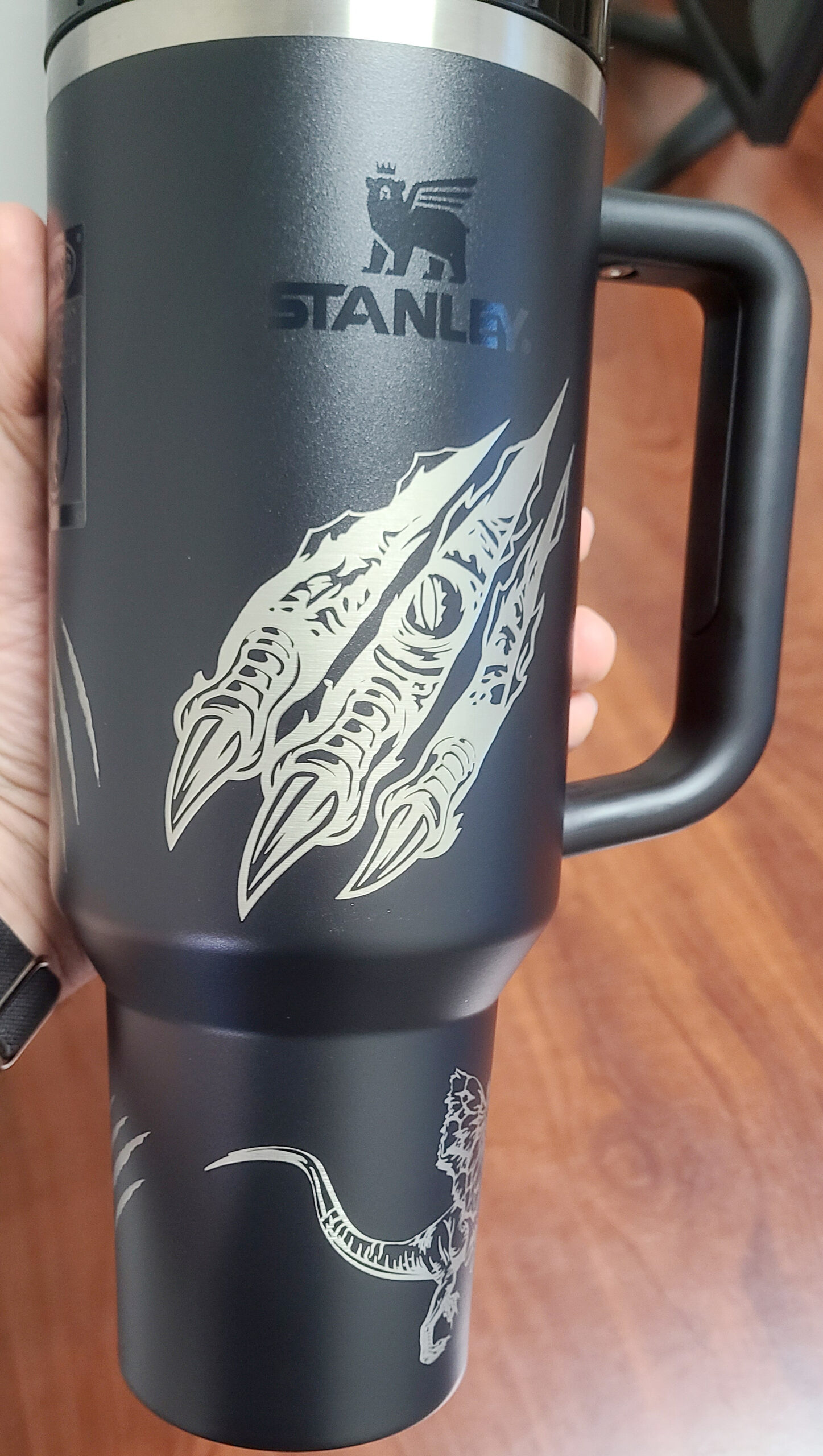 Detailed dinosaur artwork on a handled tumbler by LA LASER 1